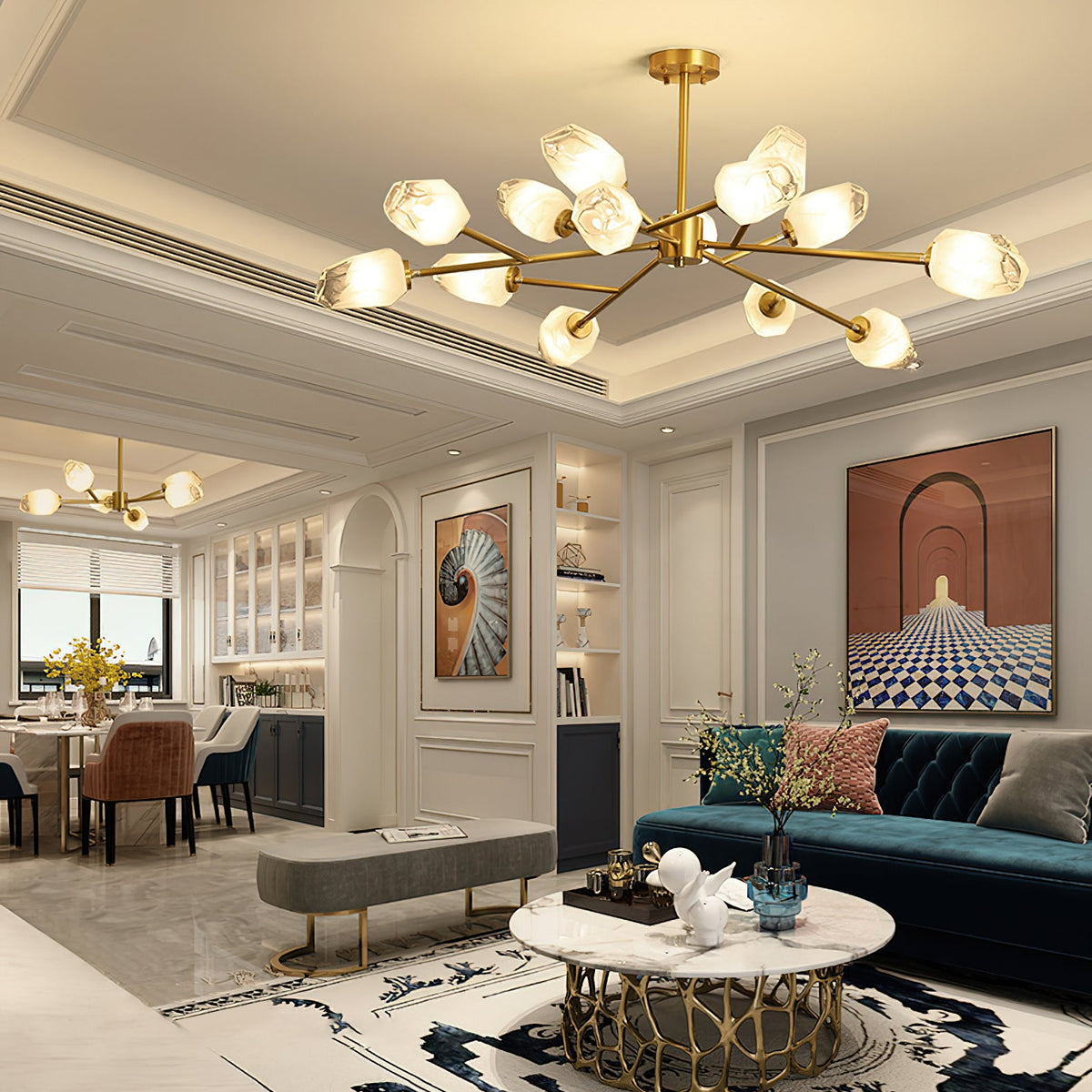A Clérachic chandelier hung low in a grand open-plan living and dining room with a teal sofa and marble coffee table.