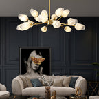 Wide-spreading chandelier in brass and frosted glass over a cream sofa, a Clérachic light in a navy-panelled lounge.