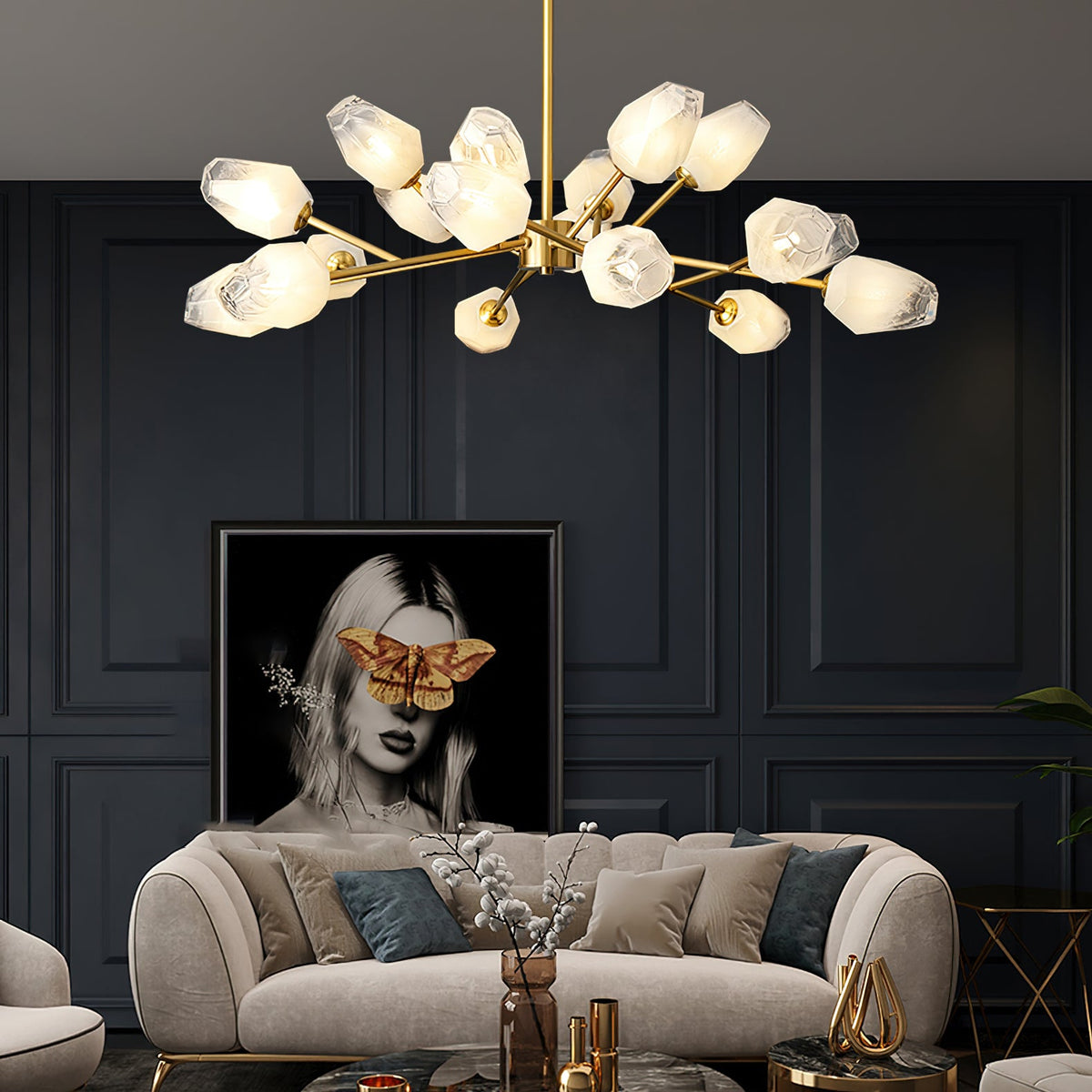 Wide-spreading chandelier in brass and frosted glass over a cream sofa, a Clérachic light in a navy-panelled lounge.