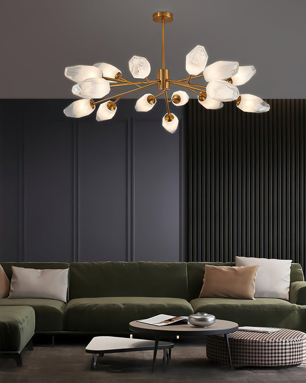 Eight-armed brass chandelier with frosted shades, a Clérachic light above a coffee table and olive-green sofa.