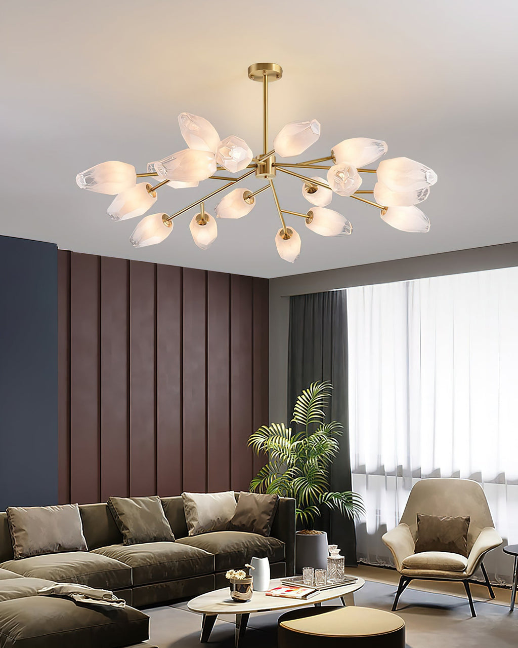Soft, warm light from the frosted glass shades of this Clérachic chandelier above a green sofa and a cream armchair.