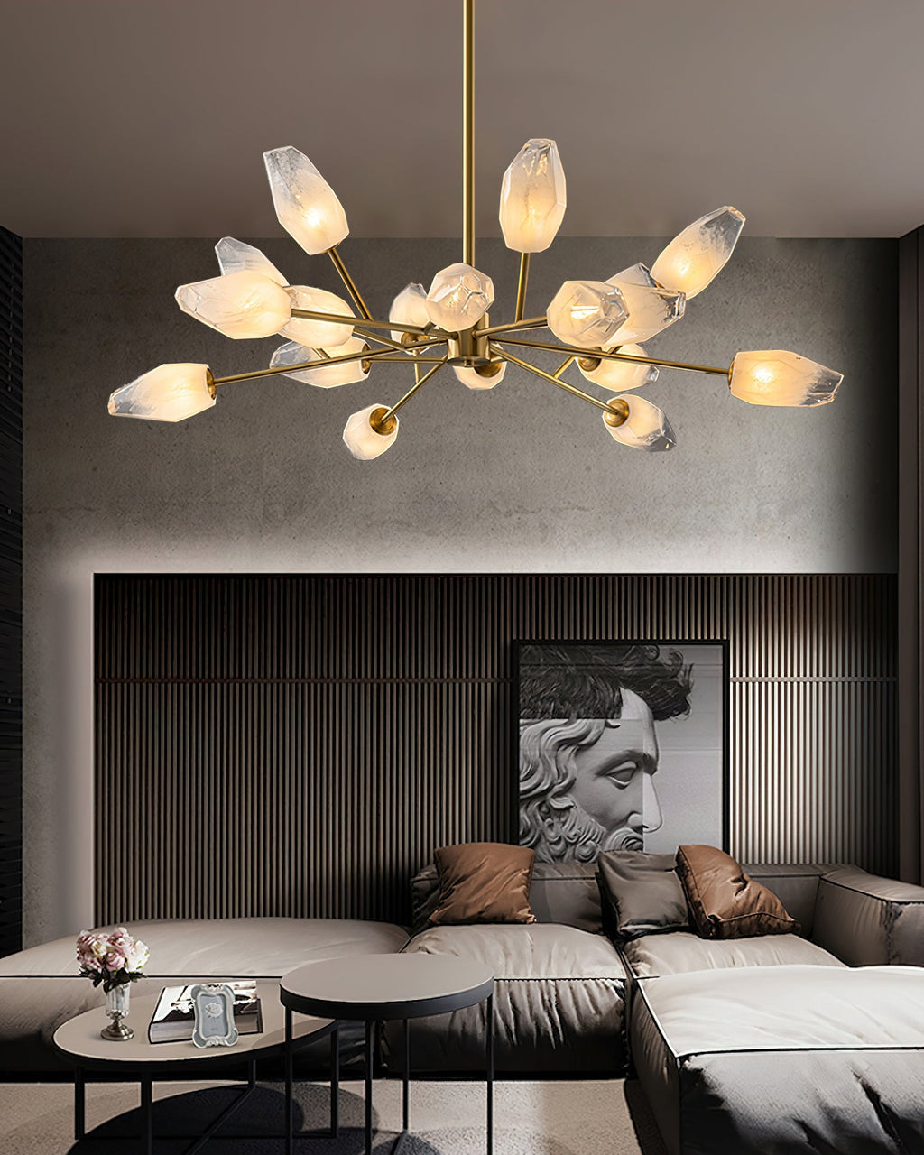 Long-armed brass chandelier lit above a corner sofa in a living room with slatted wall panels, a Clérachic light.