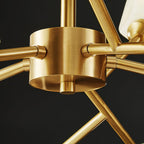 Close view of the brushed brass central hub where the arms of this Clérachic chandelier meet.