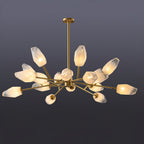 A Clérachic chandelier with many warmly lit frosted shades spread wide on a dark grey-blue studio backdrop.