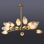 Fuller Clérachic chandelier with a brass rod and a cluster of lit frosted shades, on a dark slate backdrop.