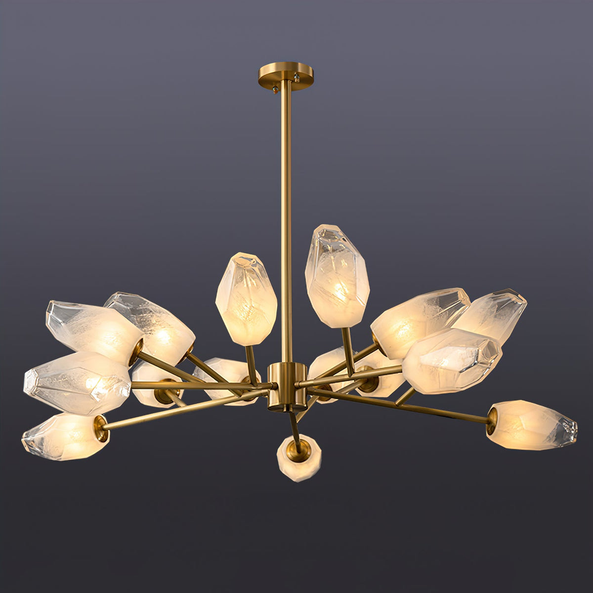 Fuller Clérachic chandelier with a brass rod and a cluster of lit frosted shades, on a dark slate backdrop.