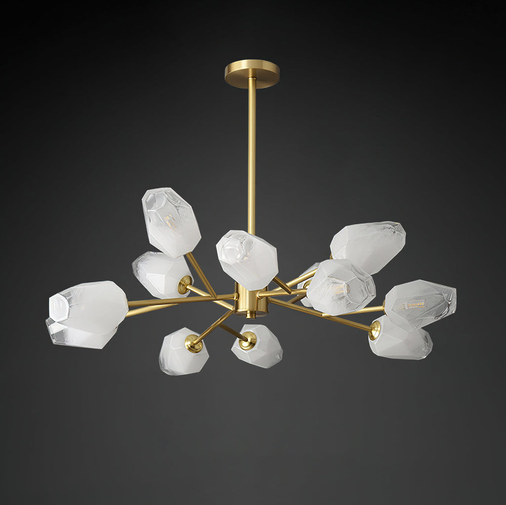 Unlit Clérachic chandelier showing its white faceted glass shades and brass arms against a black backdrop.
