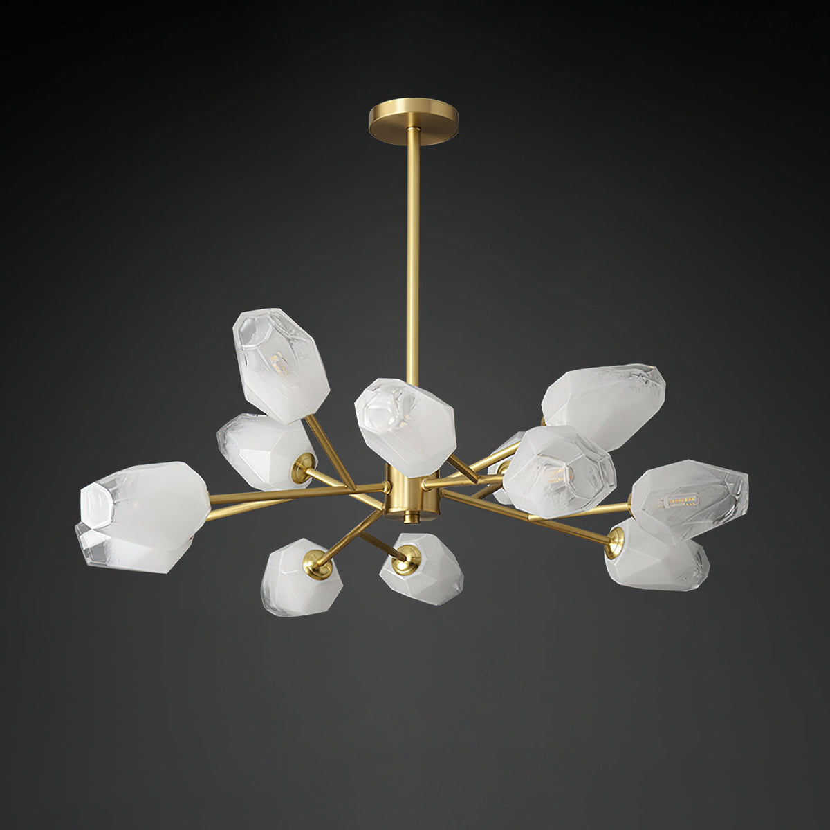 Unlit Clérachic chandelier showing its white faceted glass shades and brass arms against a black backdrop.