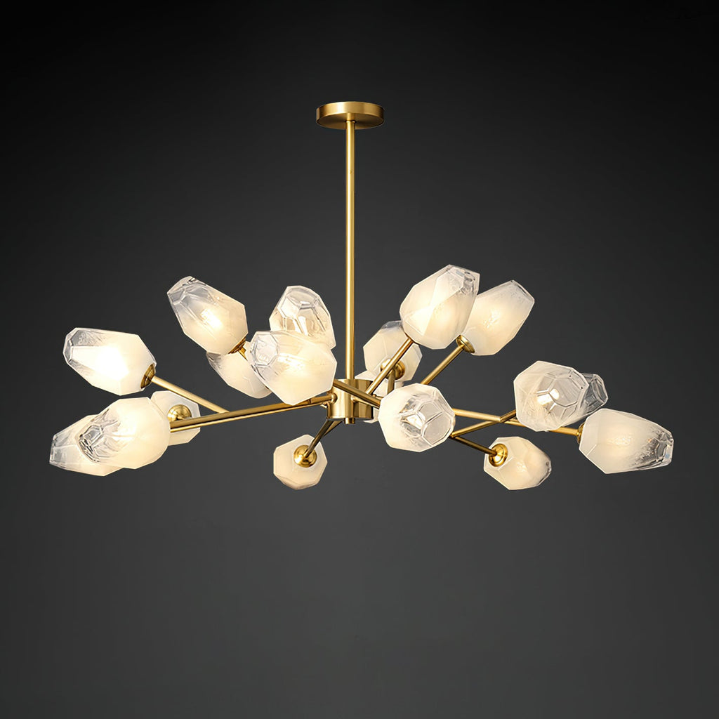 A Clérachic chandelier lit against a dark studio backdrop, with a brass rod and a wide spread of frosted shades.