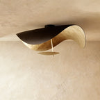 This Clérachic ceiling light shows its black top shell opening to a warm gold-leaf underside.