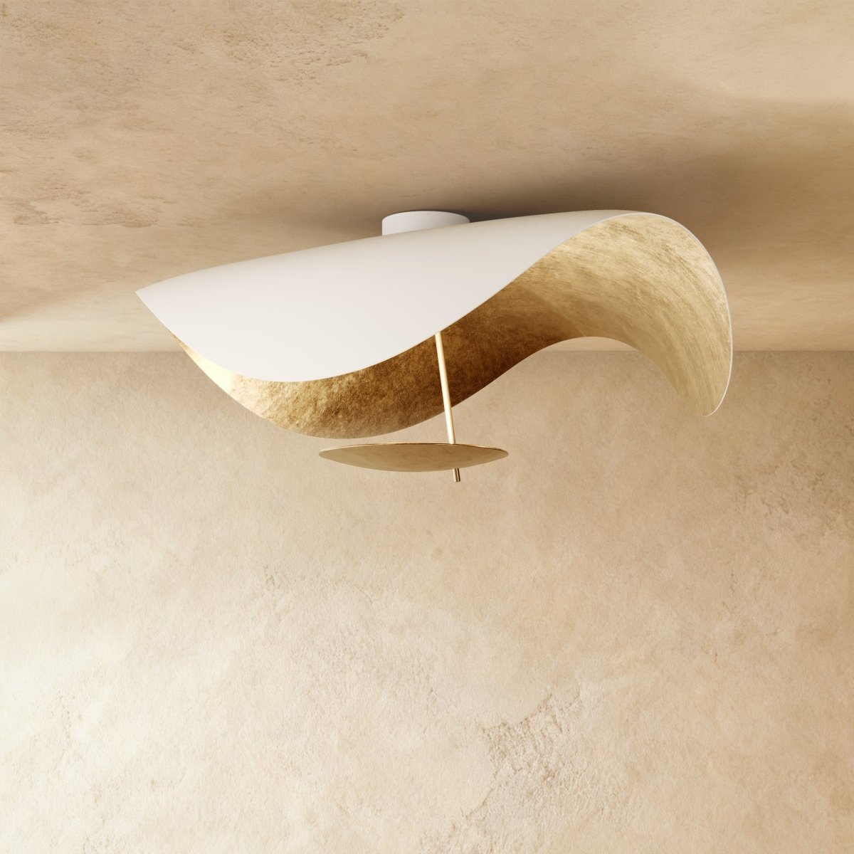 A Clérachic ceiling light in white with a gold-leaf inner curve catches the light from below.