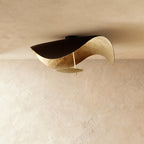 A closer view of the Clérachic ceiling light in black and gold, showing the hand-applied gold-leaf texture inside the shade.