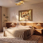 In a warm-toned bedroom, this white-and-gold Clérachic ceiling light hangs above a wood headboard and nightstand lamps.