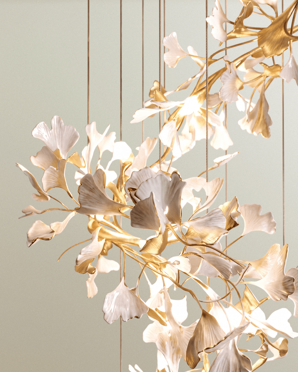 Detail of Clérachic cascade leaves in white and brushed gold, with a gold-tipped branch and warm light between them.