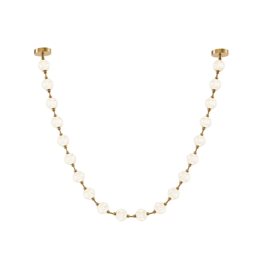 A single gold-linked strand of frosted spheres curves between two brass ceiling plates on white, the simplest form of this Clérachic pendant.