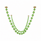 Cut-out of this Clérachic pendant in green, with a long strand of large spheres and a shorter strand of smaller beads on white.