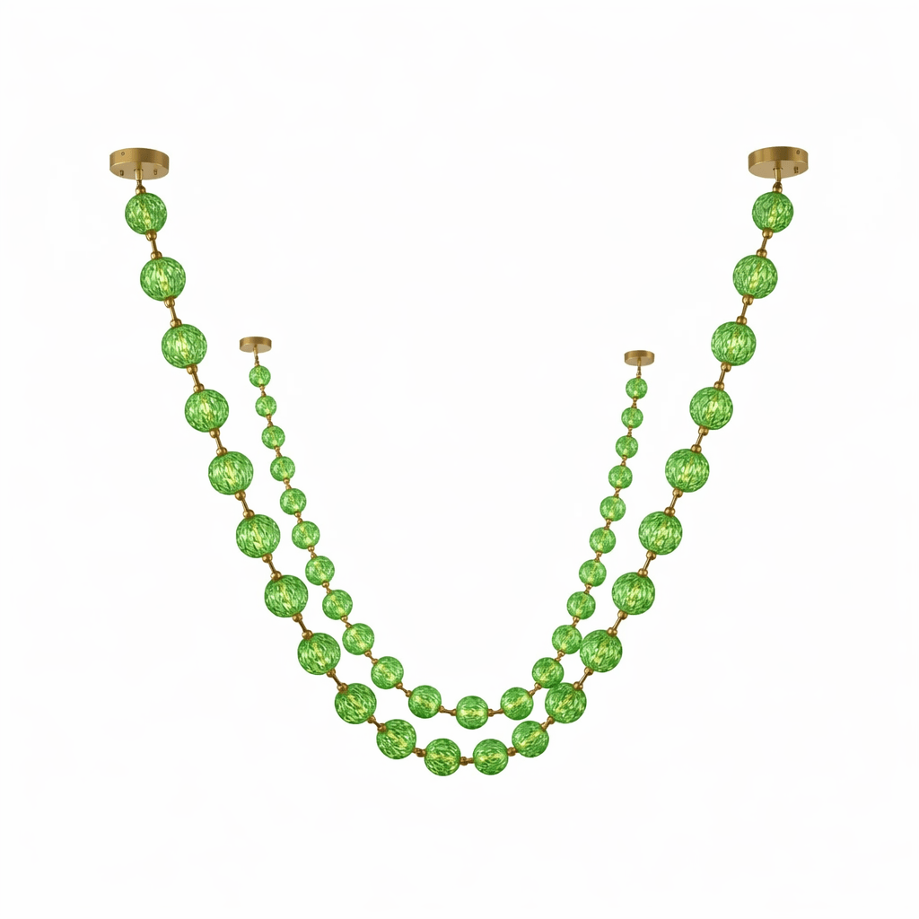 Cut-out of this Clérachic pendant in green, with a long strand of large spheres and a shorter strand of smaller beads on white.