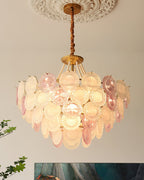 Clérachic glass-disc pendant lit beneath a carved ceiling rose, pearl strands falling from the gold canopy over the discs.