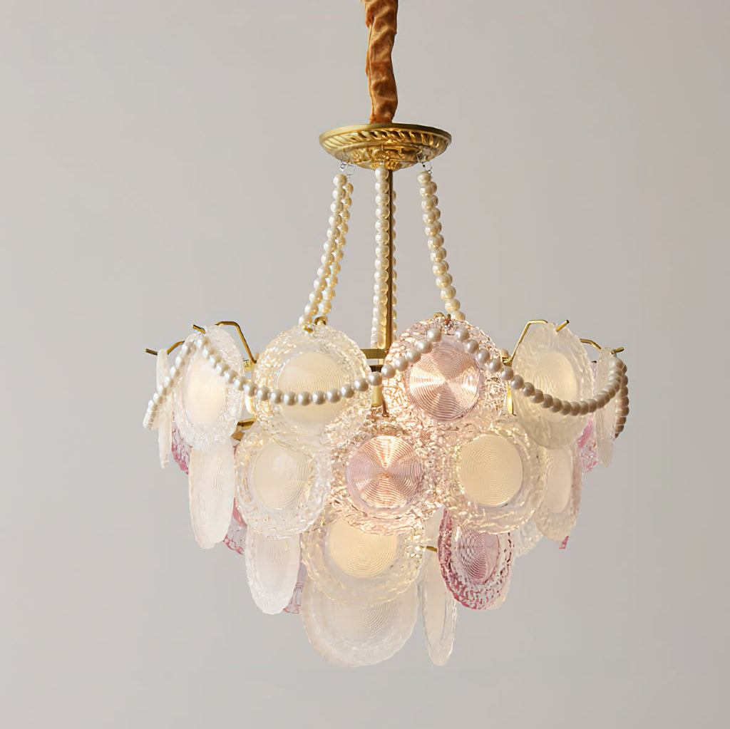 Clérachic glass-disc pendant on a grey backdrop, with a narrower tier of pink and white discs and long pearl strands.