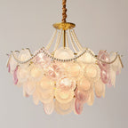 Wide Clérachic pendant, lit, with a pearl swag across its rim and a mix of pink and frosted glass discs in several tiers.