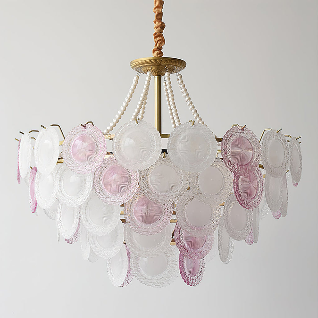 Unlit Clérachic pendant with a gold canopy, pearl strands and rows of pale pink and frosted glass discs, on a grey backdrop.