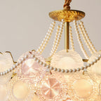Close view of the gold canopy, the pearl strands and the top rows of glass discs on this lit Clérachic pendant.