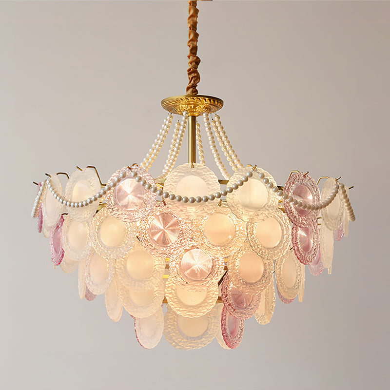 Clérachic pendant lit against grey, its pearl swags looped above overlapping pink, clear and frosted glass discs.