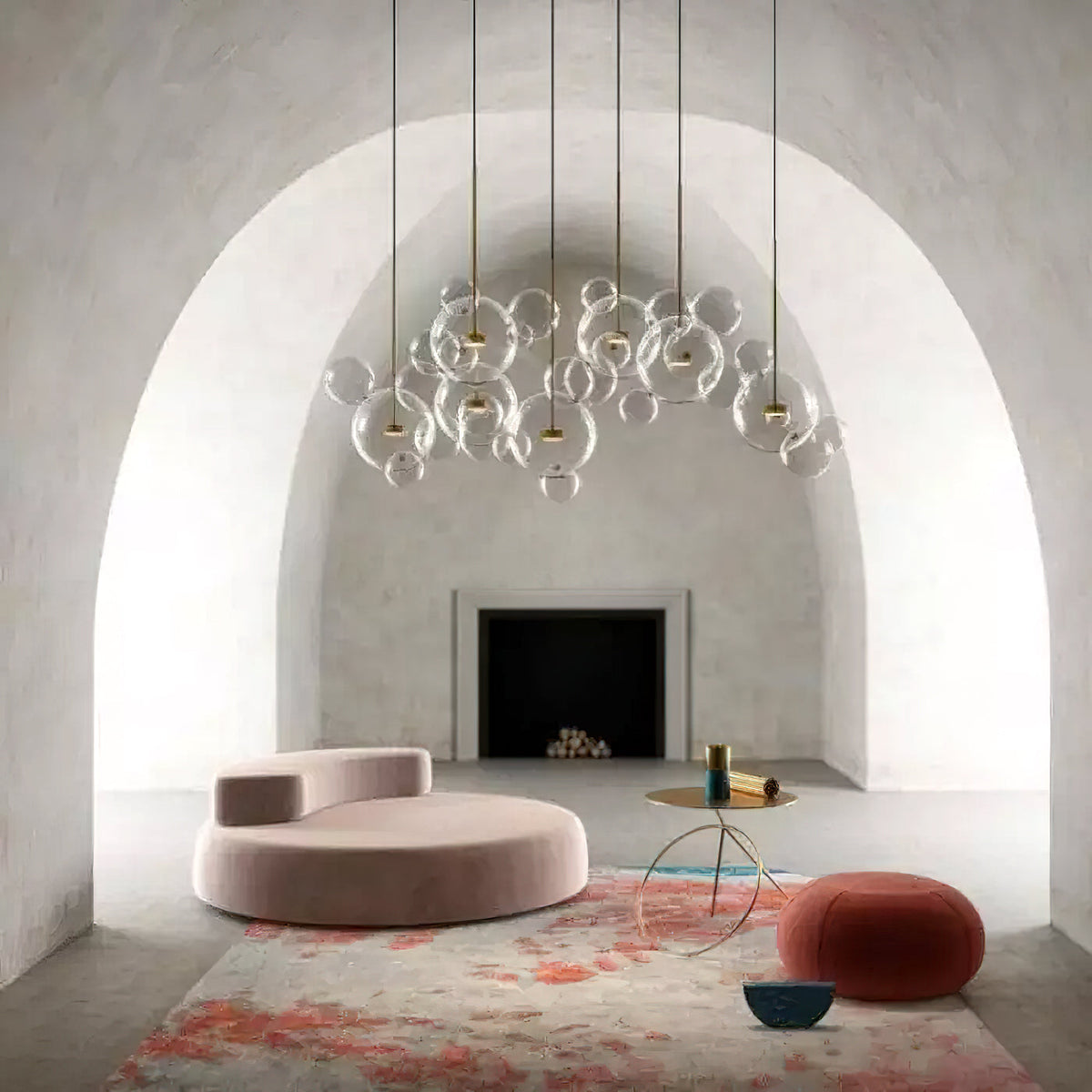 A row of Clérachic glass sphere pendants under a curved plaster arch, with a pink sofa, round pouffe and rug below.