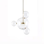 Clérachic glass sphere pendant with one large globe and three small spheres around it, on a white backdrop.