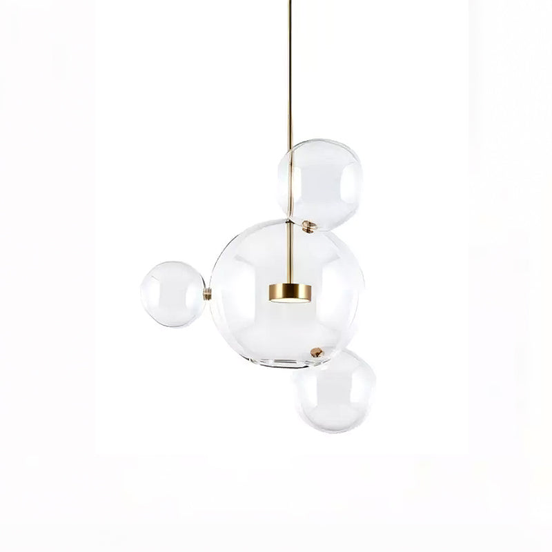 Clérachic glass sphere pendant with one large globe and three small spheres around it, on a white backdrop.