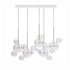 Five Clérachic glass sphere pendants on a white rectangular ceiling plate, with clear spheres between the stems.