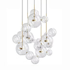 Large Clérachic glass sphere installation with many pendants and clear spheres, hung from slim dark cables on a white backdrop.