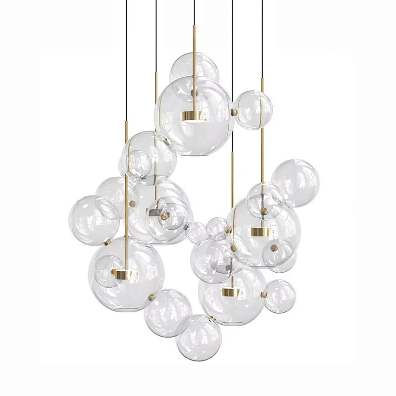 Large Clérachic glass sphere installation with many pendants and clear spheres, hung from slim dark cables on a white backdrop.