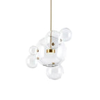 Clérachic glass sphere pendant with one large globe and several small spheres, on a gold stem against a white backdrop.