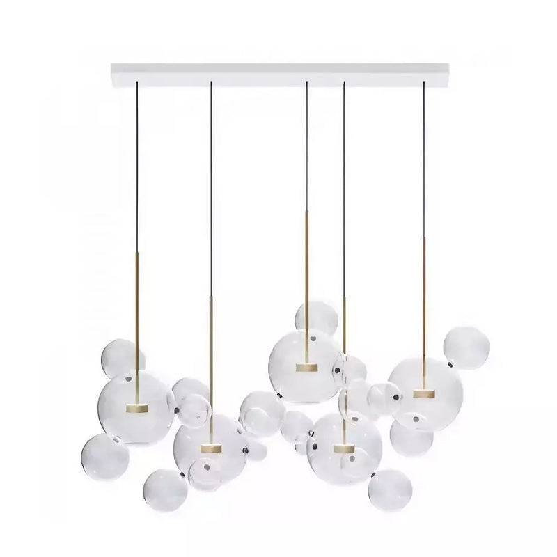 Five Clérachic glass sphere pendants hung from a white rectangular ceiling plate, with clear spheres between them.
