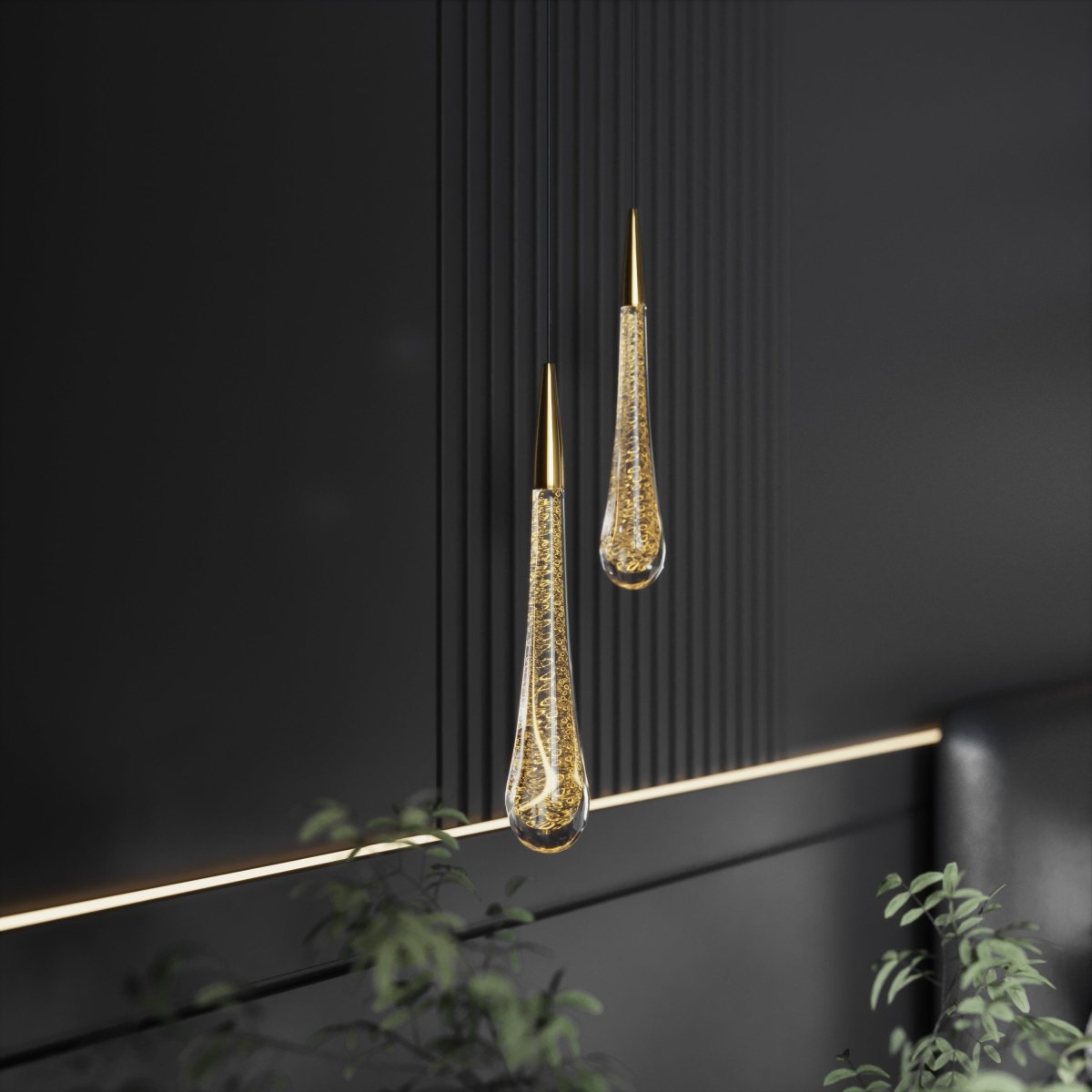Clérachic pair of brass-capped teardrop pendants with gold-flecked bubbled glass, hung against dark fluted panelling.