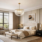 This Clérachic pendant hangs above a large bed with a cream bench at its foot, in a bedroom with tall windows and panelled walls.