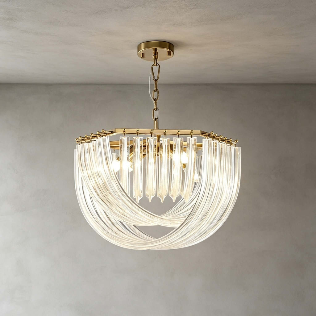 A wide, shallow Clérachic pendant with layered glass rods and gold fittings hangs on a chain in front of a grey plaster wall.