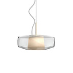 Unlit clear glass Clérachic pendant on a white backdrop, with the woven inner shade visible through the glass and a brass stem above.