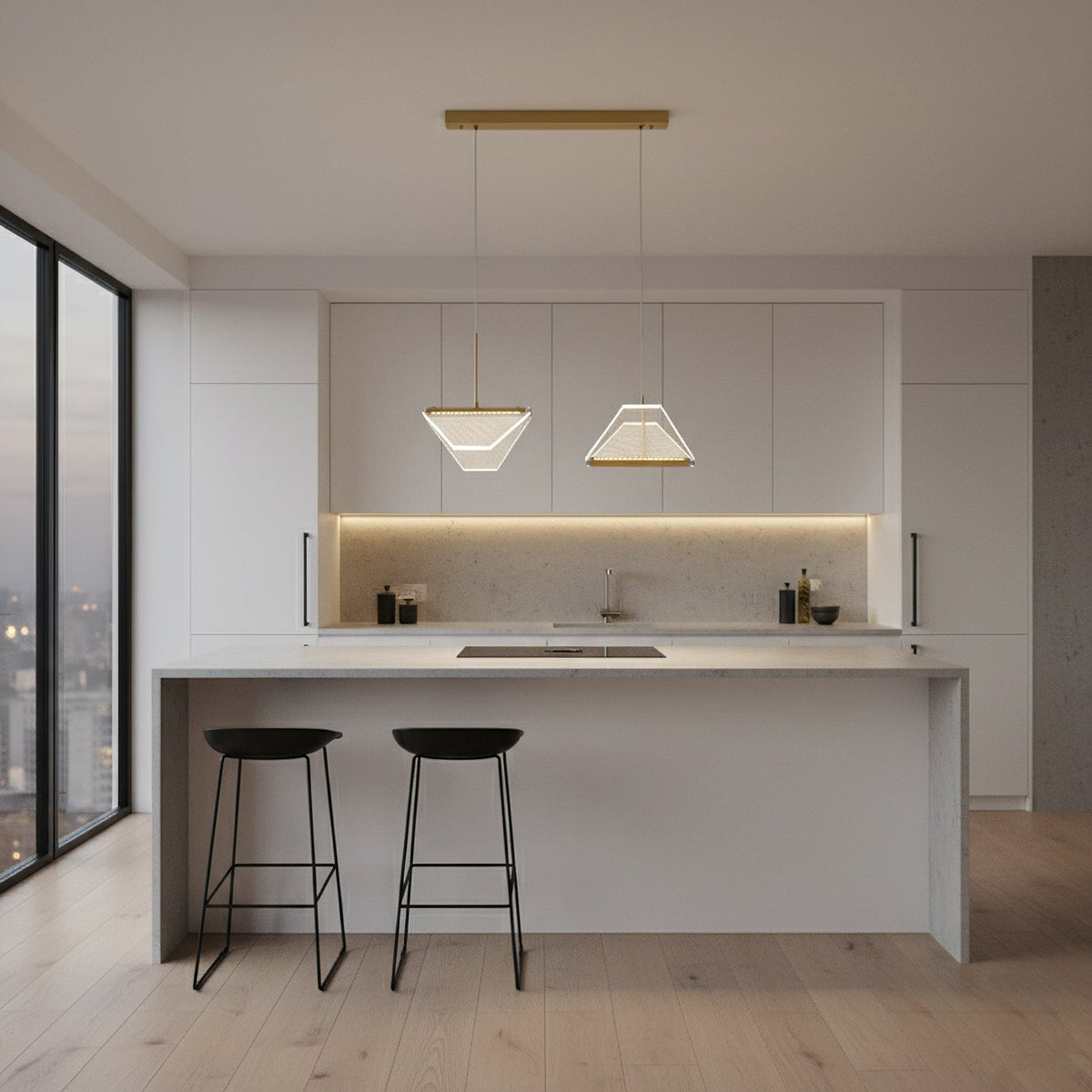 Two folded shades from this Clérachic pendant light hang side by side from a gold bar above a white kitchen island.