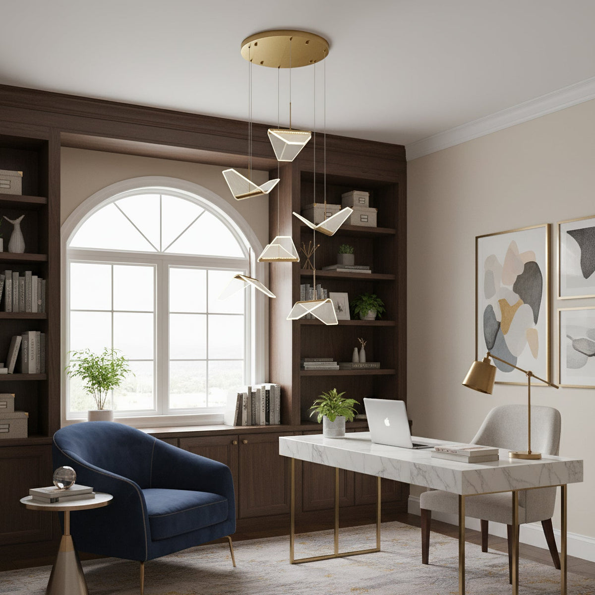 A Clérachic pendant light hangs folded shades in a study with an arched window, dark shelving and a marble-topped desk.