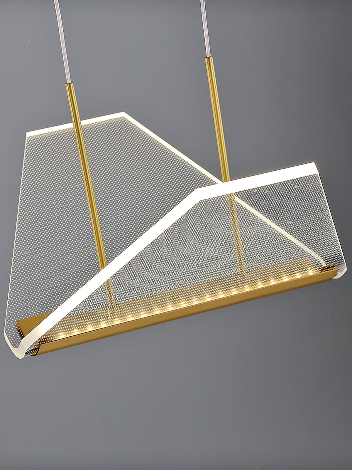 Close view of one folded clear shade of this Clérachic pendant light, with a fine mesh pattern and a row of LEDs along the gold base.