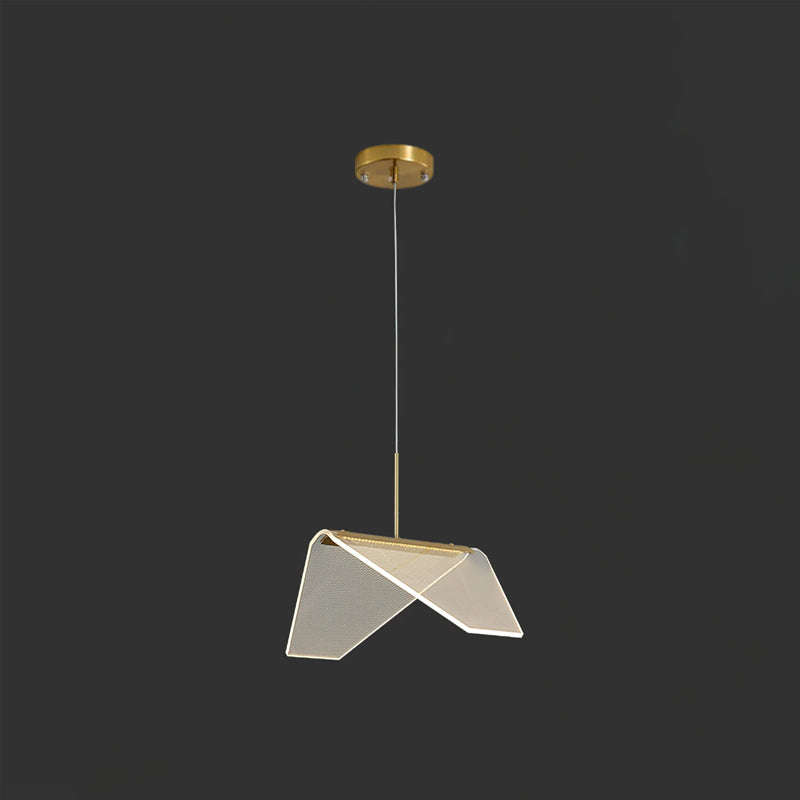 Seen slightly from the side on a dark backdrop, a folded clear shade of this Clérachic pendant light with its gold underside.