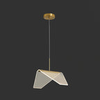 The folded clear shade of this Clérachic pendant light tilted toward the camera on a dark backdrop, with a gold base strip.