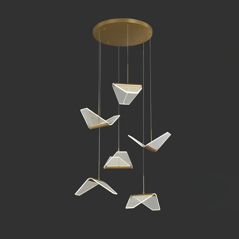 Six folded shades of this Clérachic pendant light hang at different heights from a round gold canopy, on a dark backdrop.