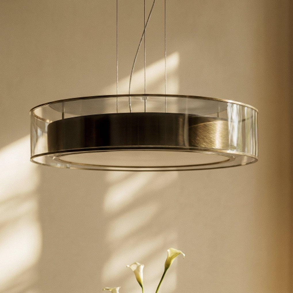 A close detail of the Clérachic pendant light's brushed brass band inside its smoked glass drum.