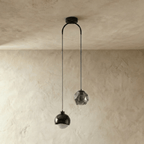 Clérachic pendant light in black, dome and faceted-glass shades on an arched ceiling canopy, unlit.