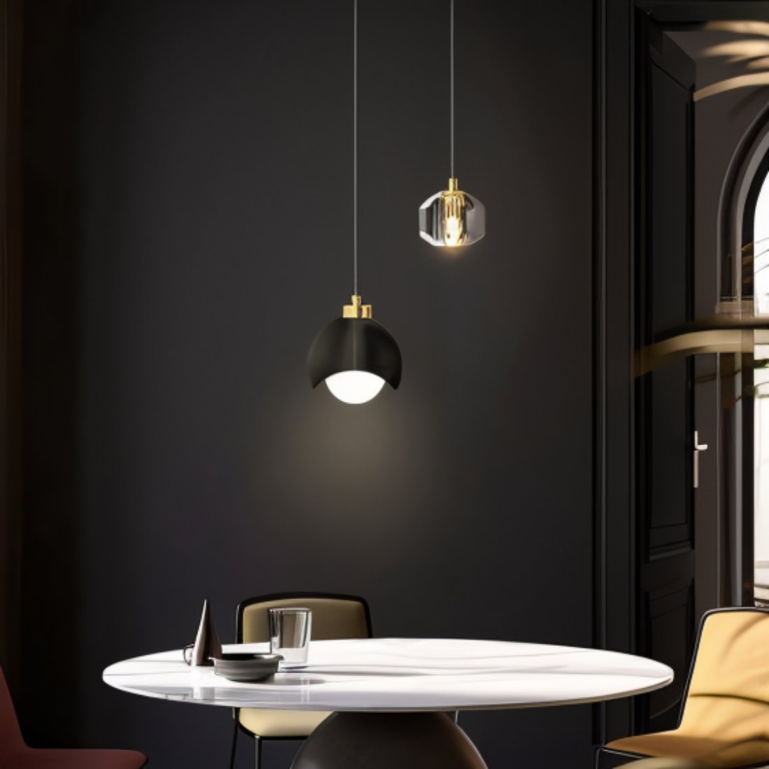 Clérachic pendant light in black lit warm above a round marble dining table in a dark, moody dining room.