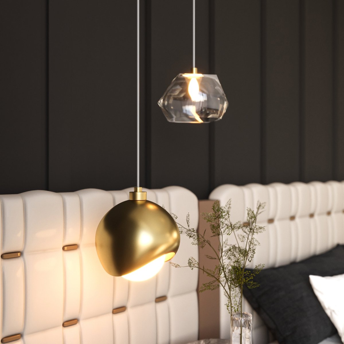 Clérachic pendant light in gold lit warm above a tufted white headboard in a dark panelled bedroom.