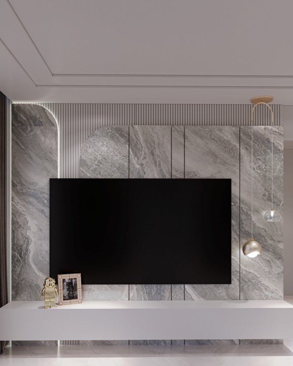 Clérachic pendant light lit warm beside a marble media wall, its dome shade reading pale under cool light.